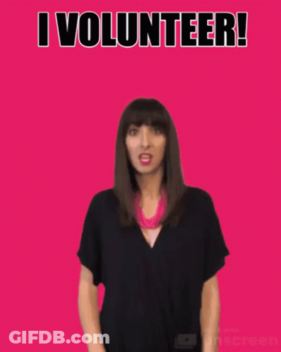 A Woman Waves Her Hand In Front Of A Pink Background With The Words I Volunteer GIF