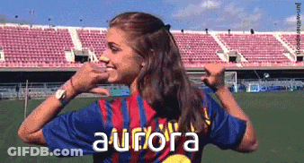 A Woman Wearing A Aurora Jersey Stands In Front Of A Stadium GIF