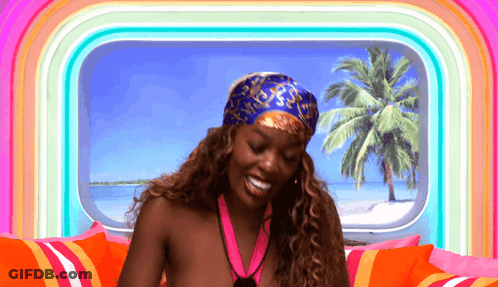 A Woman Wearing A Bandana And A Medal Is Smiling GIF