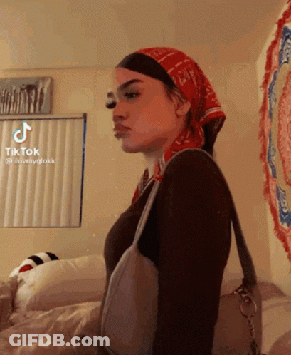 A Woman Wearing A Bandana And A Purse Has A Tiktok Account GIF