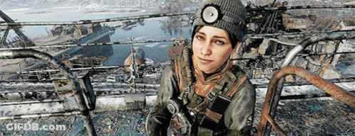 A Woman Wearing A Beanie And A Headlamp Is Sitting On A Railing . GIF