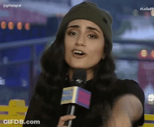 A Woman Wearing A Beanie And Holding A Microphone With The Hashtag Lollobr On The Bottom Right GIF