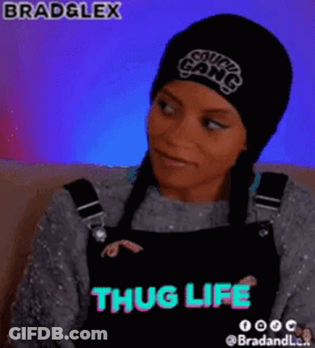 A Woman Wearing A Beanie And Overalls With The Words Thug Life On The Bottom GIF