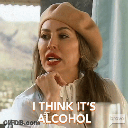 A Woman Wearing A Beret And A White Shirt Says I Think It 'S Alcohol GIF