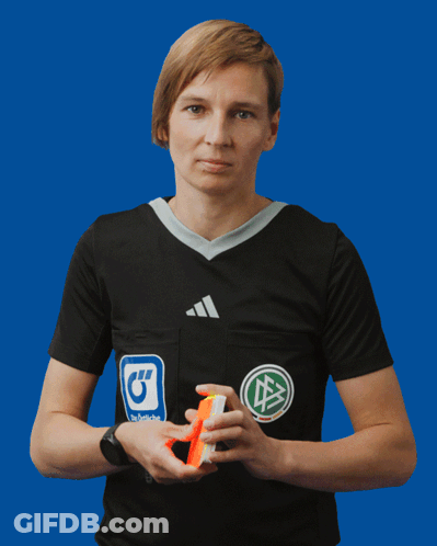 A Woman Wearing A Black Adidas Shirt Holds A Yellow Card GIF