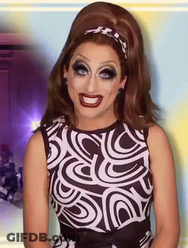 A Woman Wearing A Black And White Dress With A Swirl Pattern GIF