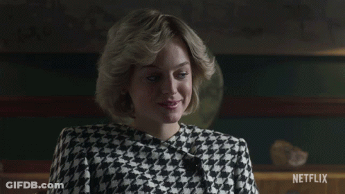 A Woman Wearing A Black And White Houndstooth Jacket Is Sitting In Front Of A Netflix Sign GIF