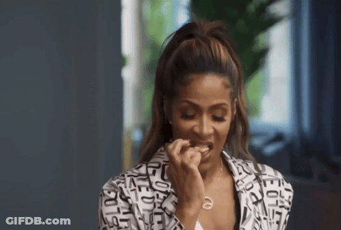 A Woman Wearing A Black And White Jacket With Letters On It GIF