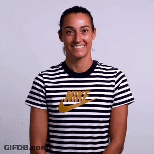 A Woman Wearing A Black And White Nike Striped Shirt GIF