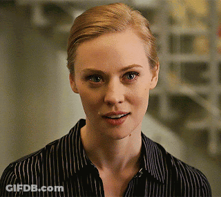 A Woman Wearing A Black And White Striped Shirt Smiles GIF