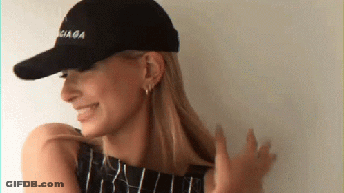 A Woman Wearing A Black Balenciaga Baseball Cap GIF