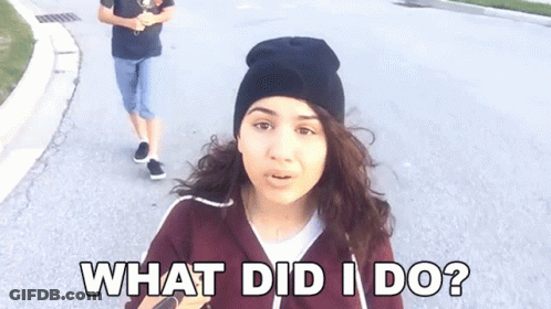 A Woman Wearing A Black Beanie Is Asking What Did I Do . GIF