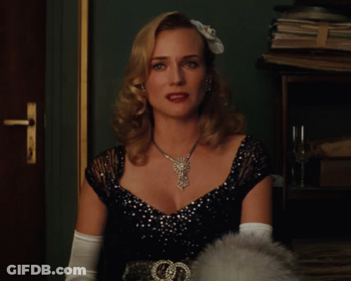A Woman Wearing A Black Dress And White Gloves Has A Necklace On GIF