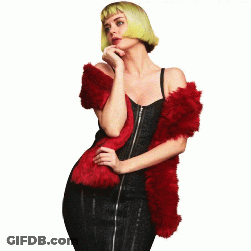 A Woman Wearing A Black Hat And A Red Furry Scarf GIF