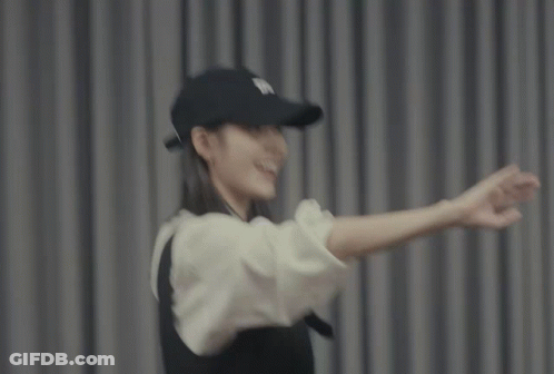 A Woman Wearing A Black Hat And A White Shirt GIF
