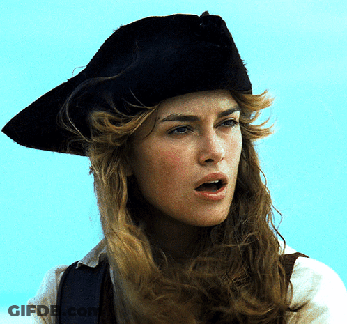 A Woman Wearing A Black Hat Looks At The Camera GIF