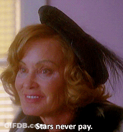 A Woman Wearing A Black Hat With The Words Stars Never Pay Below It GIF