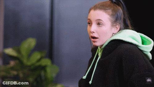 A Woman Wearing A Black Hoodie And A Green Hoodie That Says Alo GIF