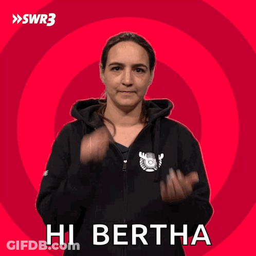 A Woman Wearing A Black Hoodie Says Hi Bertha On A Red Background GIF