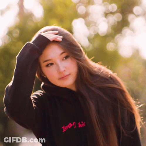 A Woman Wearing A Black Hoodie That Says Zoom I Kiss GIF