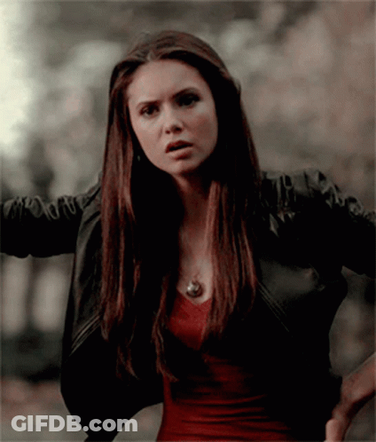 A Woman Wearing A Black Jacket And A Red Shirt GIF
