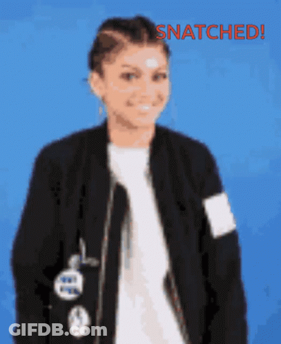 A Woman Wearing A Black Jacket And A White Shirt With The Words Snatched Written On The Bottom GIF
