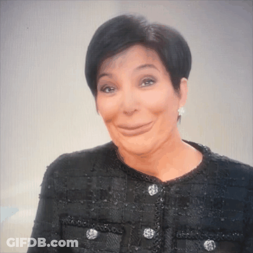 A Woman Wearing A Black Jacket And Earrings Is Making A Face GIF