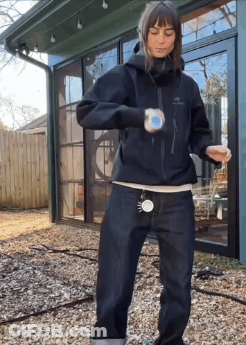 A Woman Wearing A Black Jacket That Says Arcteryx GIF