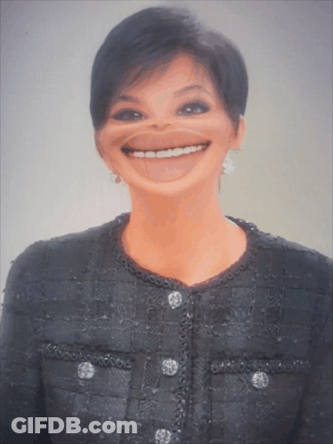 A Woman Wearing A Black Jacket With Buttons On The Front Is Smiling GIF
