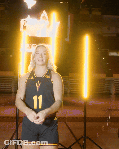 A Woman Wearing A Black Jersey With The Number 11 GIF