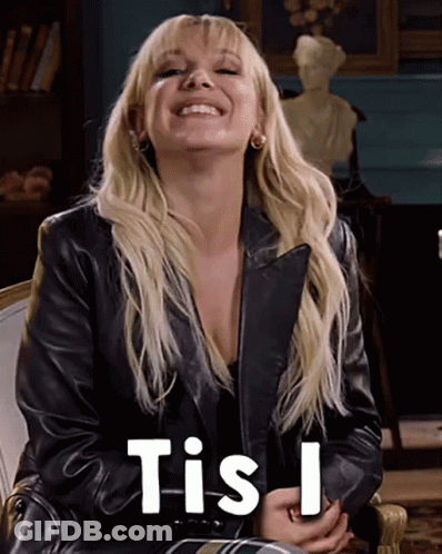 A Woman Wearing A Black Leather Jacket Is Smiling And Says Tis I . GIF