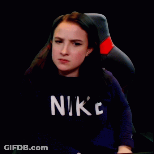 A Woman Wearing A Black Nike Shirt Is Making A Face GIF