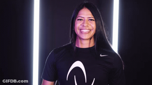 A Woman Wearing A Black Nike Shirt With The Letter V On It GIF