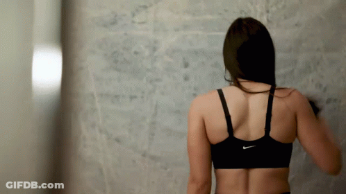 A Woman Wearing A Black Nike Sports Bra GIF