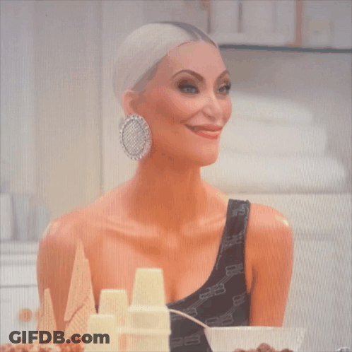 A Woman Wearing A Black One Shoulder Top With The Letters Balenciaga On It GIF