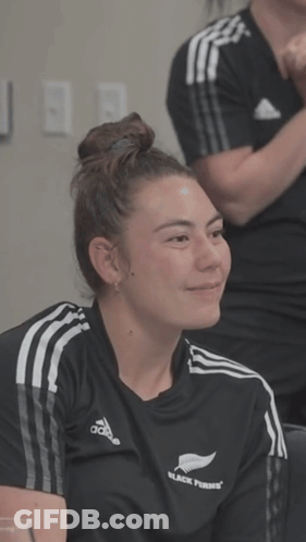 A Woman Wearing A Black Shirt That Says Black Ferns On It GIF