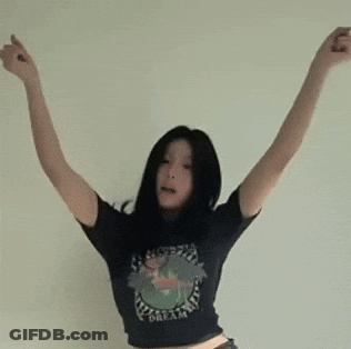 A Woman Wearing A Black Shirt That Says Dream Is Dancing With Her Arms Outstretched GIF
