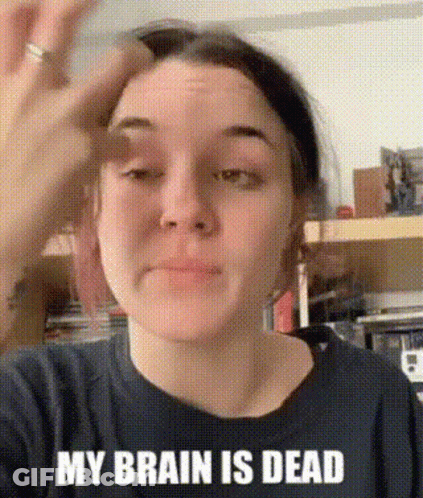 A Woman Wearing A Black Shirt That Says `` My Brain Is Dead '' Is Holding Her Hand To Her Forehead . GIF