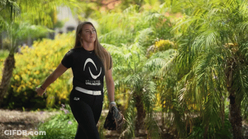 A Woman Wearing A Black Shirt That Says " Stixstar Unlimited " GIF