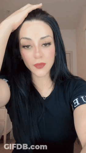 A Woman Wearing A Black Shirt That Says ' Ue ' On The Sleeve GIF