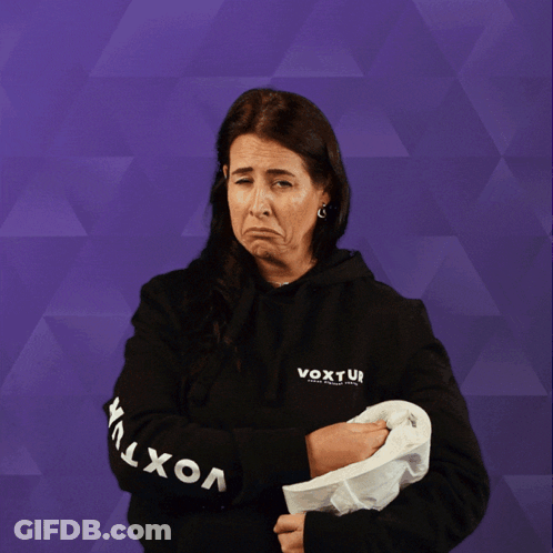 A Woman Wearing A Black Shirt That Says ' Ui ' On It Holds Up A Roll Of Toilet Paper GIF