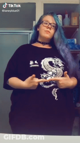 A Woman Wearing A Black Shirt With A Dragon On It GIF