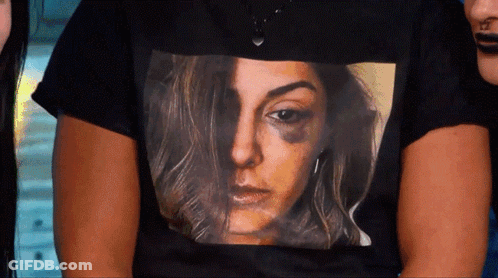 A Woman Wearing A Black Shirt With A Picture Of A Woman With A Black Eye GIF