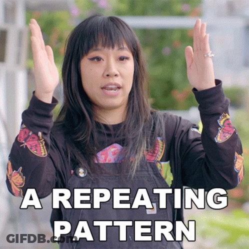 A Woman Wearing A Black Shirt With Butterflies On It Says A Repeating Pattern With Her Hands In The Air GIF