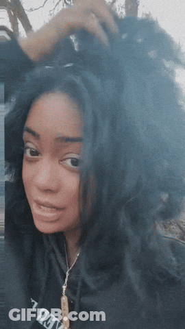 A Woman Wearing A Black Sweatshirt That Says Believe GIF