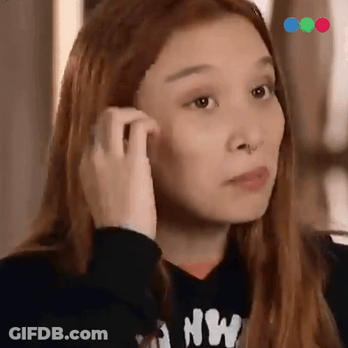 A Woman Wearing A Black Sweatshirt With The Letter Nw On It GIF