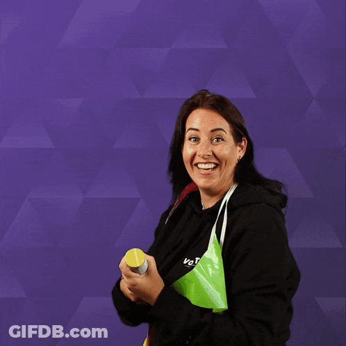 A Woman Wearing A Black Sweatshirt With The Word Vote On It GIF