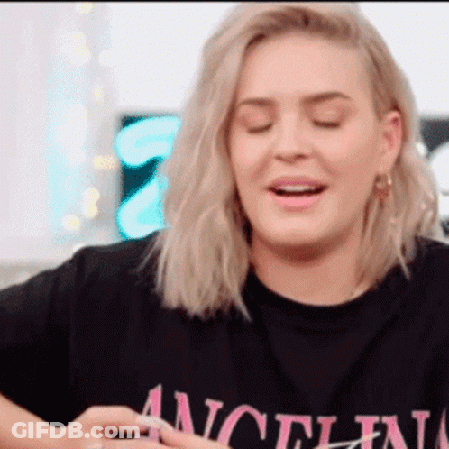 A Woman Wearing A Black T-Shirt That Says " Angel " On It GIF