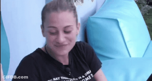 A Woman Wearing A Black T-Shirt That Says " You May Think I 'M A Dream Come True " GIF