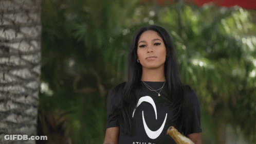 A Woman Wearing A Black T-Shirt With A White Letter C On It GIF